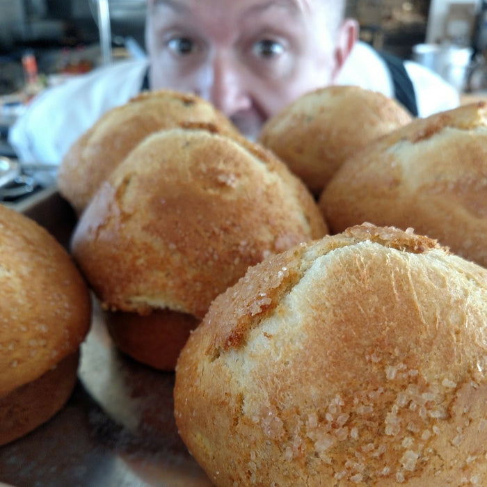 chef paul at the Dotted Lime looks at some freshly baked bread.