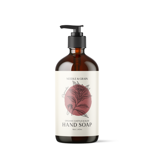 Amber glass bottle of Defender Castile Hand Soap with pump dispenser, featuring a minimalist label and natural design elements