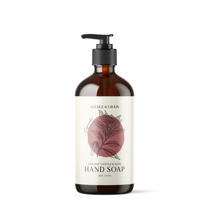 Amber glass bottle of Defender Castile Hand Soap with pump dispenser, featuring a minimalist label and natural design elements